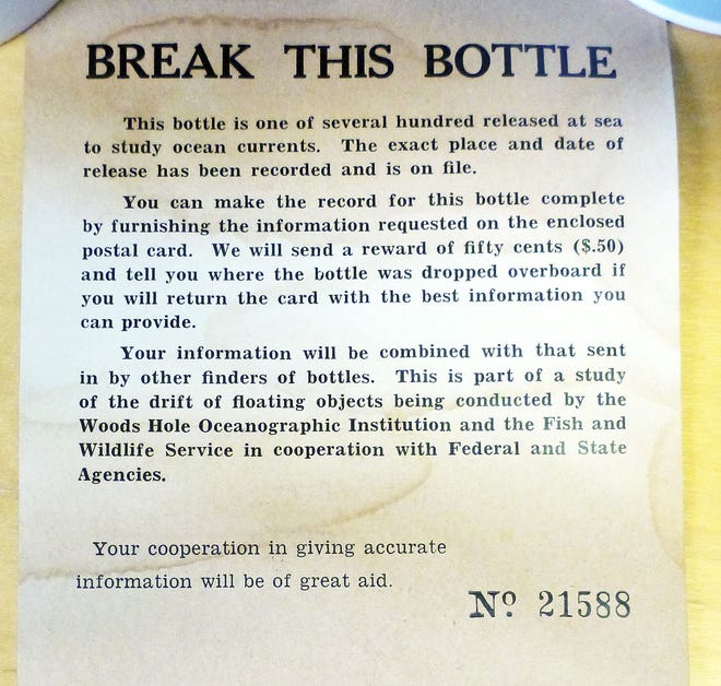 This January 2014 photo released by the Woods Hole Oceanographic Institution on Cape Cod, Massachusetts, shows a message found inside a glass bottle recovered on Sable Island, Nova Scotia, by biologist Warren N. Joyce of Canada's Department of Fisheries and Oceans.