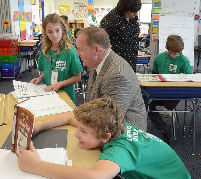 PETER.WILLOTT@STAUGUSTINE.COM As student Paden Pinder reads, classmate Kailey Papas talks to St. Johns County School superintendent Joe Joyner about her school work while school board member Beverly Slough looks over the work of Noah Lawless in a third grade class at Wards Creek Elementary School on Friday, Jan. 17, 2014. Joyner and Slough where touring the school during their third annual leadership day.