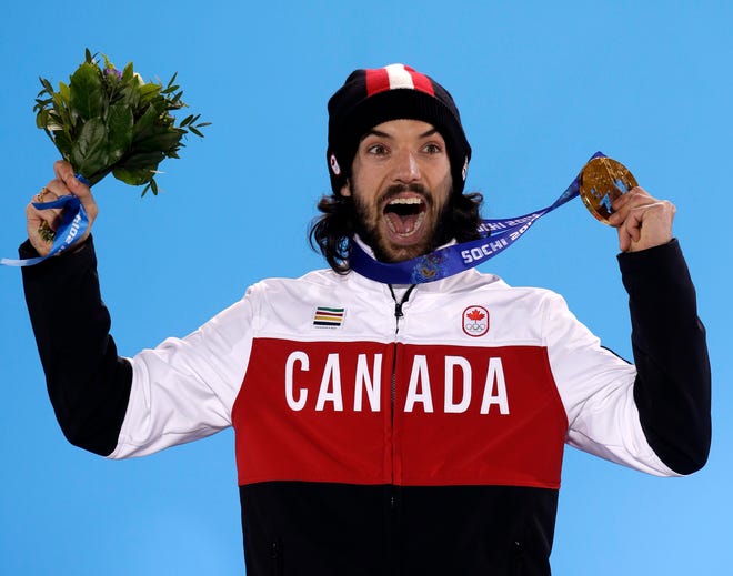 Charles Hamelin of Canada, who won the gold medal in men's 1,500-meter short track speedskating, celebrates during the medals ceremony at the 2014 Winter Olympics on Monday in Sochi, Russia.