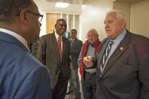 Cumberland County Commissioner candidates D.J. Haire, left, Charles Evans and Ed Melvin talk with Cumberland County Sheriff Earl 'Moose' Butler outside the Board of Elections offices Monday prior to filing for the upcoming election. The Sheriff was the first candidate in line at noon for the opening day of filing for the election.