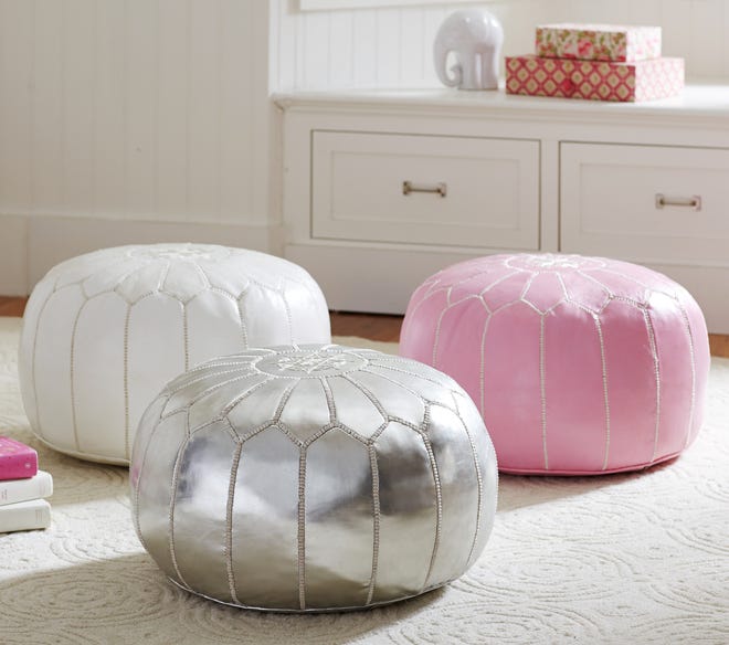 Adding in a few pink accessories freshens a great room or living room for spring. A pink pouf is a practical piece with flair.