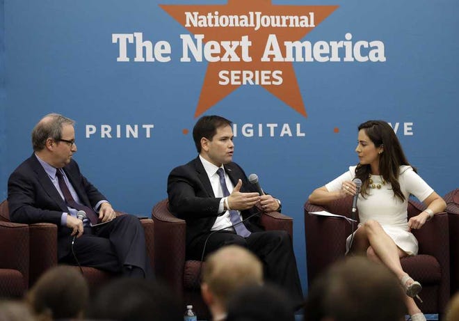 Sen. Marco Rubio, center, responds to questions posed by Ron Brownstein, editorial director of Atlantic Media, left, and Mariana Atencio of Fusion, right, following a keynote address at an event held by The National Journal at Miami-Dade College about his plans to overhaul the country's higher education system, Monday, Feb. 10, 2014, in Miami. Rubio is building on larger GOP effort to appeal to middle class voters who feel disaffected by the Republican Party. (AP Photo/Lynne Sladky)
