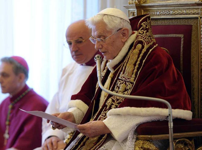 FILE - In this file photo provided by the Vatican newspaper L'Osservatore Romano on Feb. 11, 2013, Pope Benedict XVI reads a document in Latin where he announces his resignation, during a meeting of Vatican cardinals, at the Vatican. It was a holiday at the Vatican and Pope Benedict XVI was speaking in Latin at an arguably boring ceremony announcing new saints, so few people were paying much attention. But what Benedict said a year ago Tuesday changed the course of the 2,000-year-old Catholic Church and paved the way for the historic papacy of Pope Francis. In his soft voice and in a Latin that the cardinals present strained to understand, Benedict announced that he no longer had the "strength of mind and body" to be pope and would retire at the end of the month, the first pope to step down in more than half a millennium. (AP Photo/L'Osservatore Romano, ho)