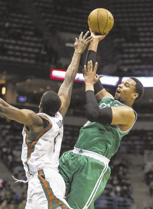 Milwaukee's Ekpe Udoh tries to block Celtics forward Jared Sullinger's shot during the first half of Monday's game in Milwaukee.