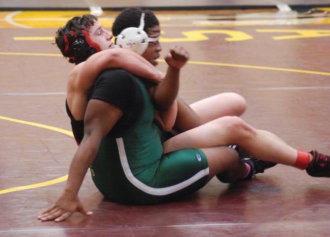 Metamora’s Jared Ambrosch grapples with his Richwoods opponent at the East Peoria regional Saturday. Ambrosch placed third to advance to the sectional.