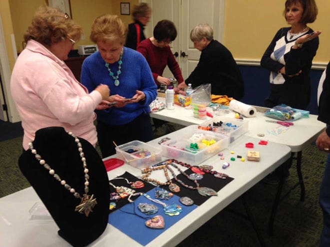 Courtesy of Sun City Community Association Residents sift through craft materials at a Make It & Take It class.