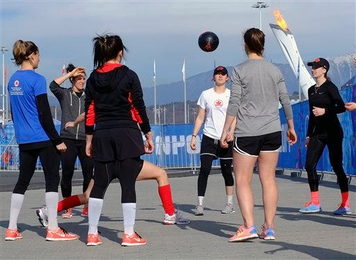 Members of the Canadian women's ice hockey team warm up outside before their game against the United States during the 2014 Winter Olympics women's ice hockey tournament at Shayba Arena, Wednesday, in Sochi, Russia.
