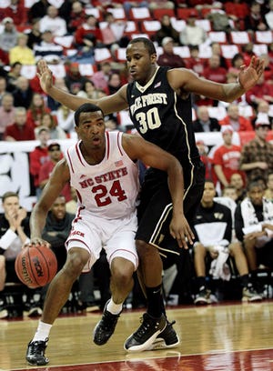 North Carolina State's T.J. Warren drives to the basket against Wake Forest's Travis McKie on Tuesday night.