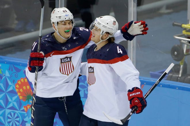 United States defenseman John Carlson (right) celebrates with forward James van Riemsdyk after scoring during the U.S.'s 7-1 win over Slovakia on Thursday.
