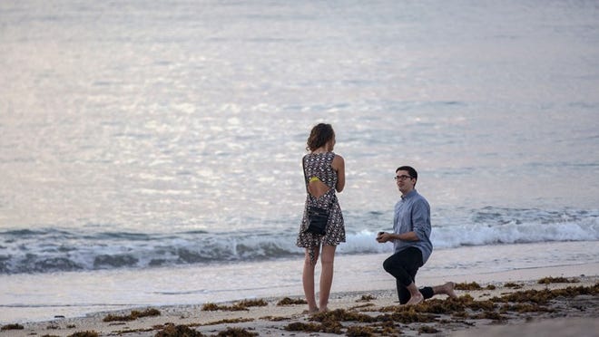 She said yes! Jerome McCann of London, U.K. picked sunrise at Midtown Beach as the perfect time to propose to Ally Green, of San Antonio, Texas Friday, August 19, 2016. The couple met while McCann was an exchange student at Texas A&M University in 2015, and have made several trips across the Atlantic to keep in touch since. They are in south Florida visiting Ally's grandparents. The wedding will have to wait until Jerome finishes his post graduate work in 9 months, at which time he plans to immigrate to the US  (Lannis Waters / Daily News)