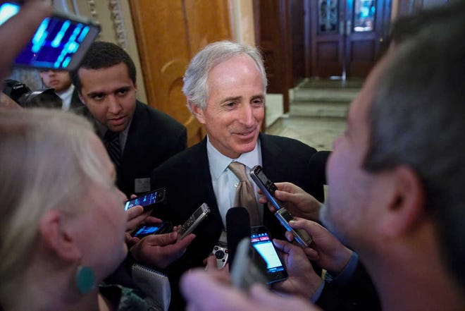 Sen. Bob Corker, R-Tenn., speaks to reporters outside the Senate chamber on Capitol Hill in Washington, Wednesday, Feb. 12, 2014, during maneuvering on the vote to extend the Treasury's borrowing authority. The debt limit measure was passed by the House Tuesday. (AP Photo/J. Scott Applewhite)