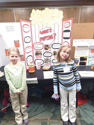 Soo Township third-graders Kadence Gorsuch and Alaina Frappier tested which brand of popcorn pops the most kernels.