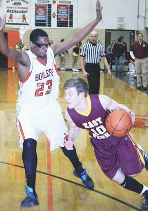 Kewanee’s Kentrel Welcome (23) tries to stop the baseline drive of East Peoria’s Sean Mulhern Thursday night.
