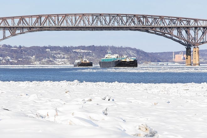 Two barges on the icy Hudson River are pushed by tugboats on Tuesday near the Newburgh Beacon Bridge.