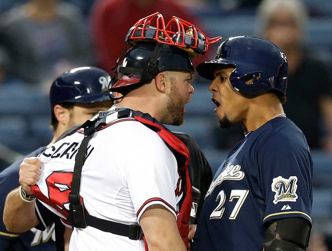 Milwaukee center fielder Carlos Gomez (right) exchanges words with ex-Atlanta catcher Brian McCann after a home run. The dust up led to a clearing of both team's benches.