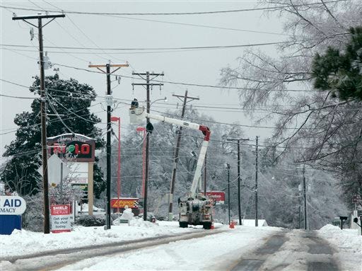 A power crew works to repair lines off highway 176 Thursday, Feb. 13, 2014, in Chapin, S.C. At the peak of the winter storm 350 thousand costumers were without power. Now that the snow and ice have ended in South Carolina, hundreds of thousands of residents are waiting for power to return so life can get back to normal. (AP Photo/Mary Ann Chastain)