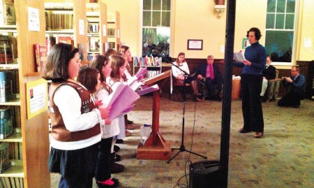 Teacher Kate Smith (right) leads the 200th Birthday Chorus in its performance at the Incorporation celebration.