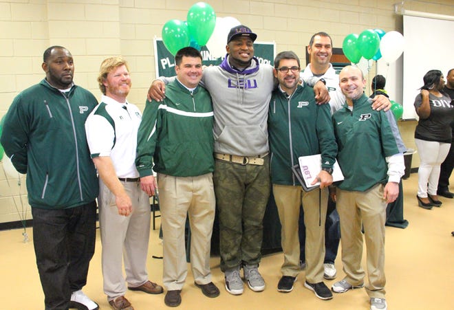Plaquemine's Davon Godchaux is surrounded by coaches following his football scholarship signing to LSU on National Signing Day Wednesday morning at the school field house. From left, Peter Villia, Scott Allen, Cory Alleman, Godchaux, Plaquemine head football coach Paul Distefano, John Barbee and Hunter Markins.
POST SOUTH PHOTO/Peter Silas Pasqua
