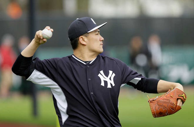 Pitcher Masahiro Tanaka threw 32 pitches in a bullpen session during his first official workout with the Yankees after signing a $155 million deal.