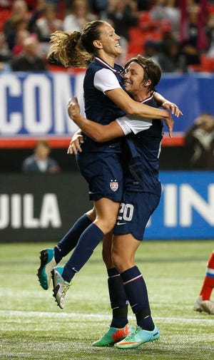 United States'Lauren Holiday (12) celebrates with Abby Wambach (20) after scoring during the second half of a an exhibition soccer match against Russia on Thursday, Feb. 13, 2014, in Atlanta. The United States won 8-0. (AP Photo/John Bazemore)