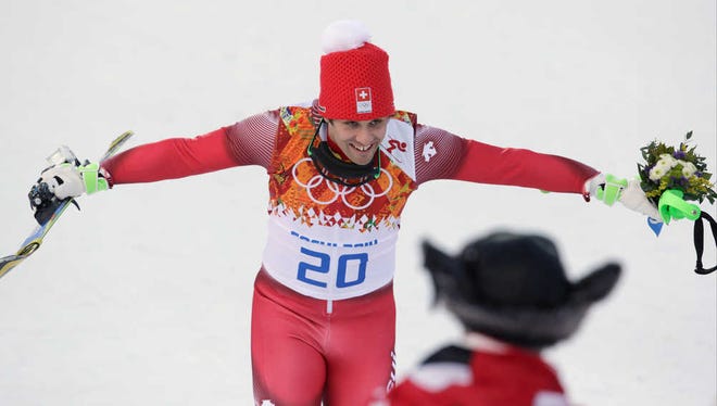 Men's supercombined gold medal winner Switzerland's Sandro Viletta celebrates after a flower ceremony at the Sochi 2014 Winter Olympics, Friday, Feb. 14, 2014, in Krasnaya Polyana, Russia. (AP Photo/Charles Krupa)