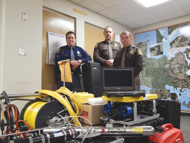 Divemaster Steven Derusha of the Michigan State Police Dive Team inventories new equipment with Chippewa County Undersheriff Mike Bitnar and Sheriff Robert Savoie. The new equipment, funded through a federal grant, will assist the dive team in future recovery and investigation efforts.