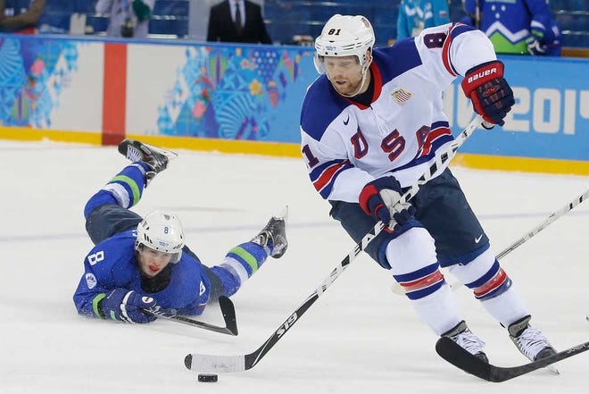 United States forward Phil Kessel (right) skates away from Slovenia's Ziga Jeglic. Kessel became the first American to record a hat trick at the Olympics since John LeClair did it against Finland during the 2002 Games in Salt Lake City.