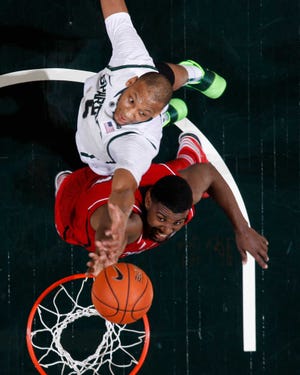 Nebraska's Leslee Smith, bottom, and Michigan State's Adreian Payne fight for a rebound during the second half.
