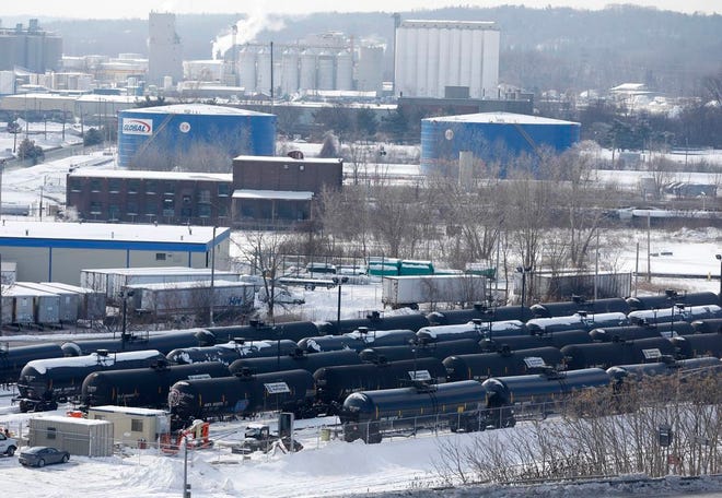 A view from a nearby apartment building shows vehicles driving along Interstate 787 past railroad oil tanker cars that are lined up at Global Partners at the Port of Albany.