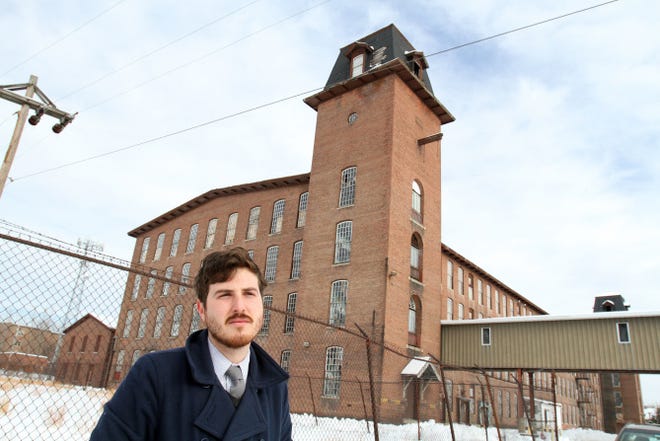 Steve Larrick, planning and economic development coordinator in Central Falls, stands in front of the former mill complex known as The Thread Factory.