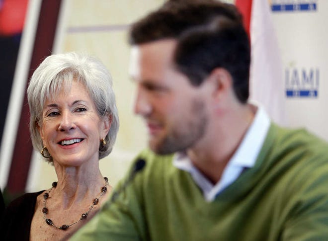 U.S. Secretary of Health and Human Services Kathleen Sebelius, left, smiles as she listens to Allan Zullinger, 28, a law student at Florida International University who related stories of his experiences with health insurance as a so-called "young invincible," during a news conference for the kick-off of National Youth Enrollment Day, Saturday, Feb. 15, 2014 at the Joe Celestin Center in North Miami, Fla. Dozens of organizations in Florida and around the country were participating in events to target "young invincibles." Insurers are counting on "young invincibles" to offset the costs of covering older, sicker enrollees. (AP Photo/Wilfredo Lee)