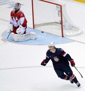 USA forward T.J. Oshie reacts after scoring the winning goal against Russia goaltender Sergei Bobrovski in a shootout during overtime of a men's ice hockey game at the 2014 Winter Olympics, Saturday, Feb. 15, 2014, in Sochi, Russia. (AP Photo/David J. Phillip )