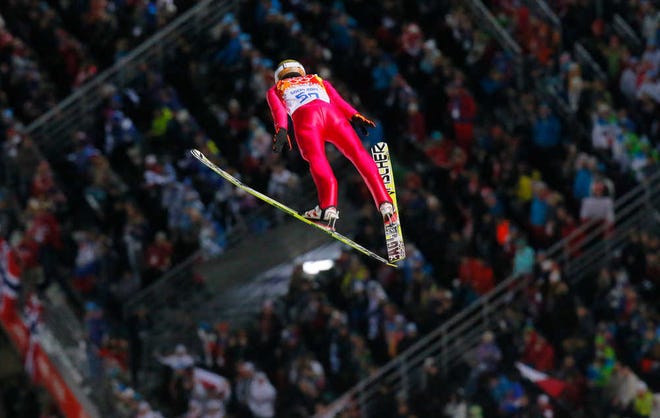 Poland's Kamil Stoch makes his first attempt during the ski jumping large hill final at the 2014 Winter Olympics, Saturday, Feb. 15, 2014, in Krasnaya Polyana, Russia. (AP Photo/Dmitry Lovetsky)
