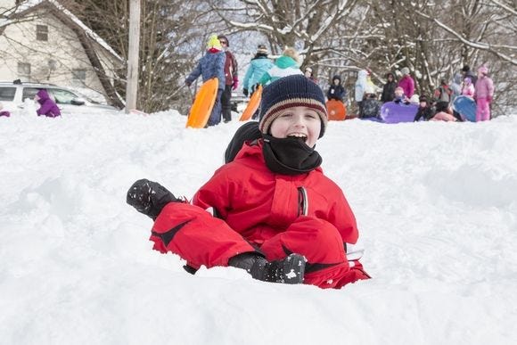 Seven year-old Michael Kelly of Warwick enjoying a ride down the snow covered hill at Stanley Deming Park on Friday.