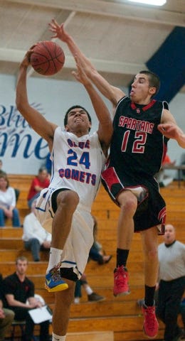 AHS' Robert Bittle tries for a dunk but was fouled by The Spartans' Derek Chavis. (PAUL CHURCH / THE COURIER-TRIBUNE)