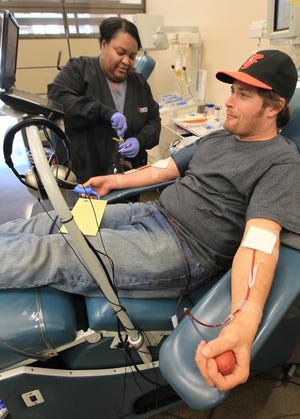 Due to the recent snow keeping donors away from blood banks, the area is short on blood. Here, phlebotomy technician Everly Tipps watches over donor J.D. Elmore as he donates platelets at the Community Blood Center on East Franklin Blvd Tuesday morning, February 18, 2014.