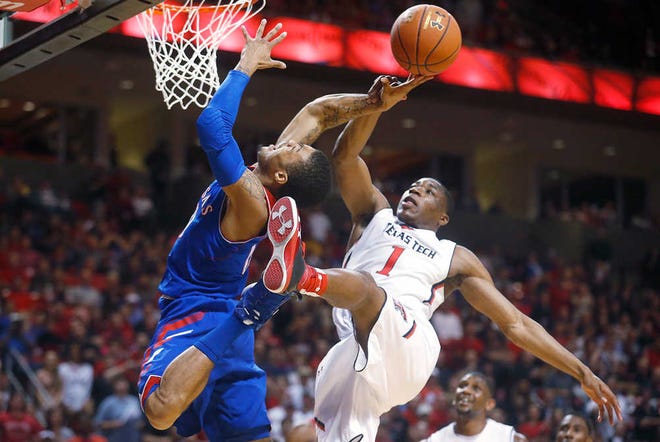 Kansas' Frank Mason (0) is fouled by Texas Tech's Randy Onwuasor (1) during the Jayhawks' to-the-wire 64-63 victory Tuesday night in Lubbock.