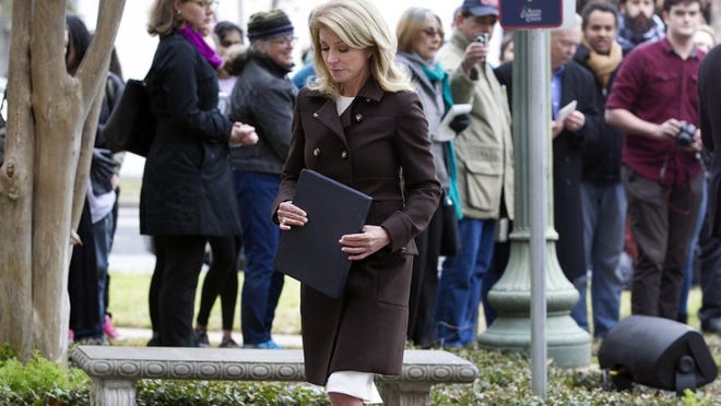 State Sen. Wendy Davis, D-Fort Worth, leaves the podium following a news conference on school financing Monday at the Austin Community College Rio Grande Campus.