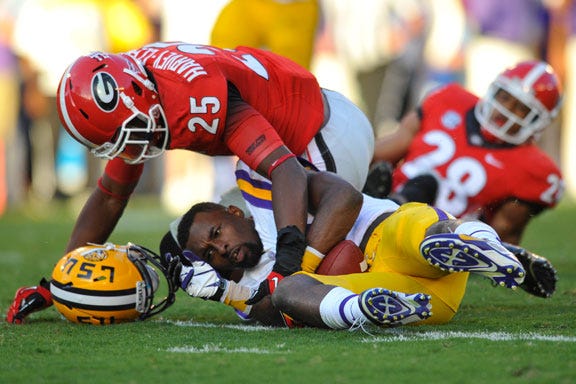 LSU wide receiver Jarvis Landry (80) loses his helmet after a hit from Georgia safety Josh Harvey-Clemons (25) during the second half of the NCAA college football game between the Georgia Bulldogs and the Louisiana State Tigers in Athens, Ga., Saturday, Sept. 28, 2013.