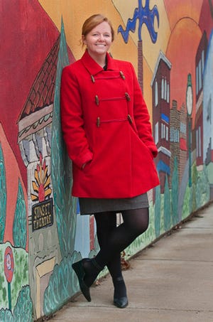 Leigh Anna Johnson poses at the mural on Church Street in Asheboro 2.5.14.(PAUL CHURCH / THE COURIER-TRIBUNE)