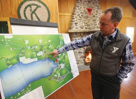 Photo by Daniel Freel/New Jersey Herald - Bob Kahle, executive director of Fairview YMCA Camps and Conference Center, points out on a map the camp’s master plan during a ground-breaking ceremony to replace the Minisink Lodge, which burnt down in 2012.