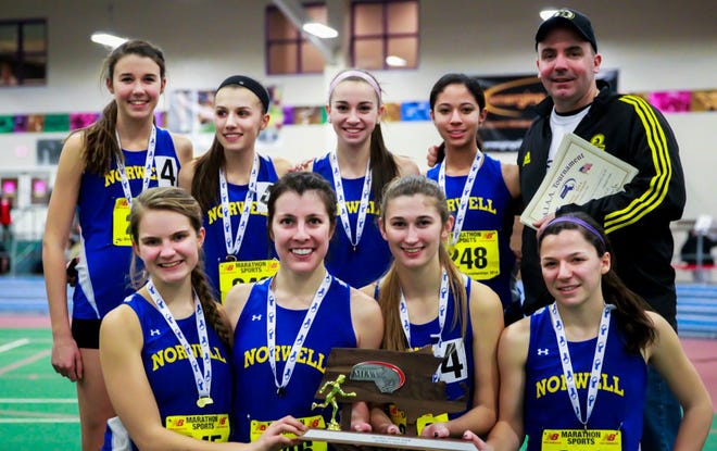 The Norwell High girls track team shows off its second-place trophy from the Division 5 State Meet.