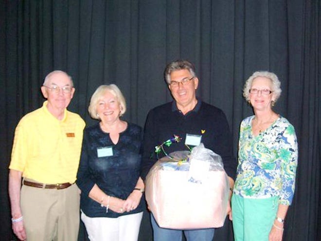 George Olson, current president of the Destin Snowbird Club, and Nancy Hewitt, president for next season, presented Pam and David Hawes of Great Britain a basket as the “snowbirds who came the farthest.”