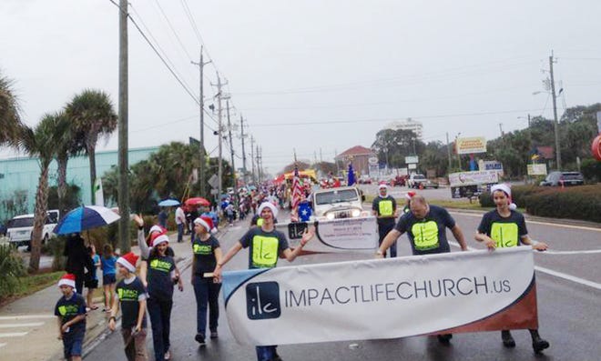 Volunteers from Impact Life Church braved the rain and participated in the Destin Christmas parade.