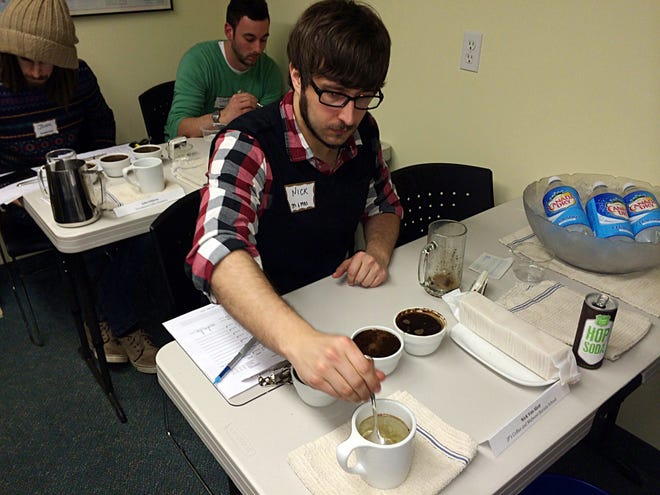 Nick Van Slett, JP's director of coffee, participates in a blind taste test during the "Great Kopi Luwak Cupping Challenge" on Thursday. Contributed