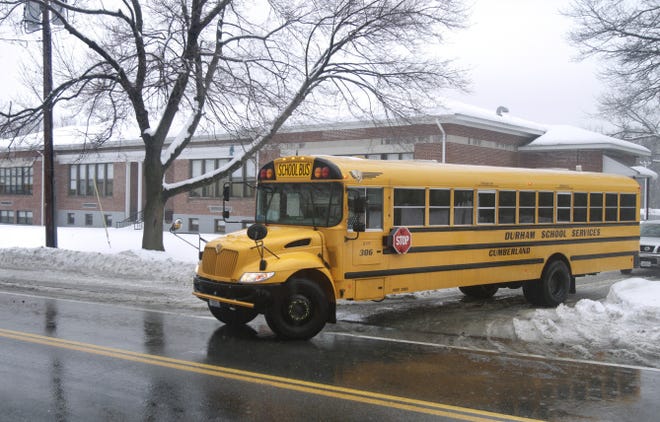 Buses leave the Garvin Memorial School in Cumberland on Wednesday as students are dismissed for the day.
