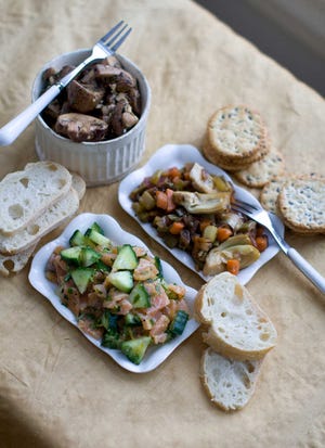 From top clockwise, balsamic marinated mushrooms, artichoke caponata and smoked salmon tartare in Concord, N.H. (AP Photo/Matthew Mead)