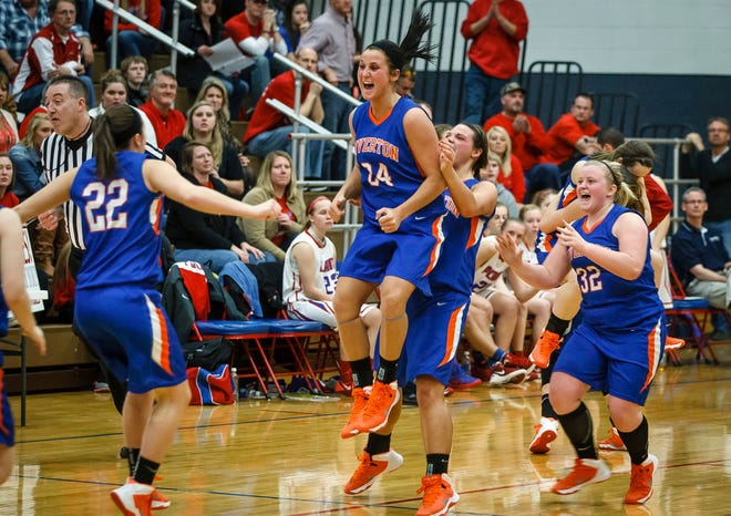 Riverton’s Carlie Cuffle jumps while celebrating with teammates Thursday night after the Hawks beat Pleasant Plains 46-36 to win the Class 2A Carlinville Sectional. JUSTIN L. FOWLER/THE STATE JOURNAL-REGISTER