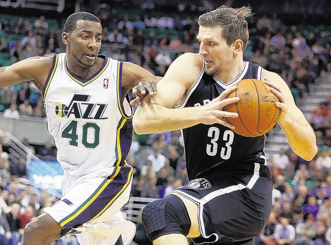 Nets' Mirza Teletovic, right, drives while defended by Jazz's Jeremy Evans on Wednesday.