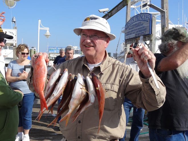 Larry LaDassor of Minnesota was all smiles as he held up his stringer of mingo and white snapper caught aboard the Destiny with Capt. Chris McConnell.